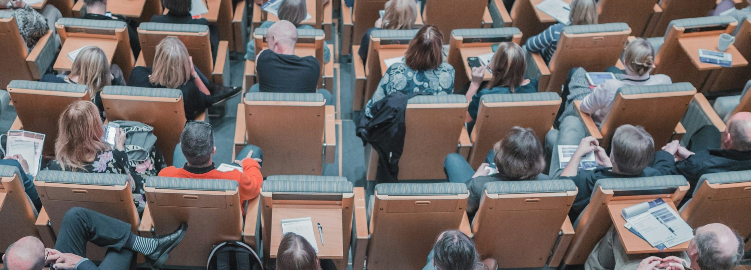 A birdseye view of a lecture hall filled with students.